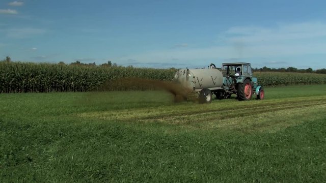 Framer spreading or fertilizing liquid manure on a field, Germany.