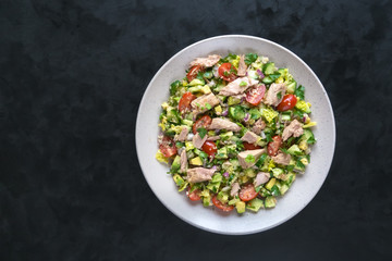 Fresh vegetable salad with tuna slices. Top view.
