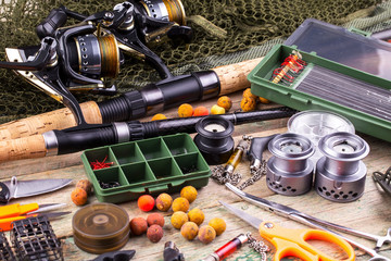 fishing tackle on a wooden table. toned image 