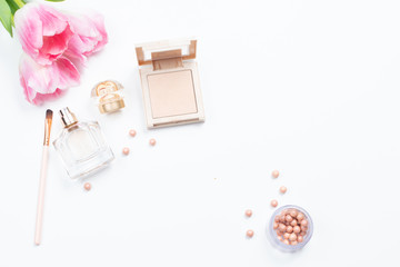  Cosmetics and pink tulips on white background