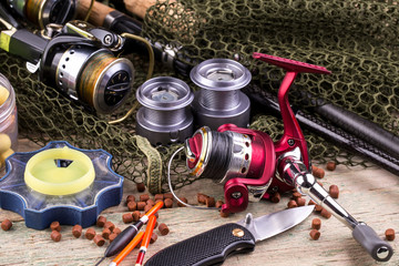 fishing tackle on a wooden table. toned image 