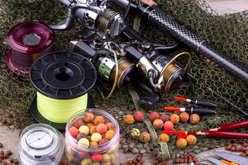 fishing tackle on a wooden table. toned image 