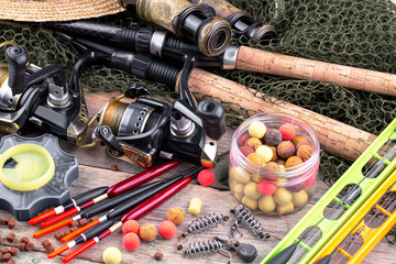 fishing tackle on a wooden table. toned image 