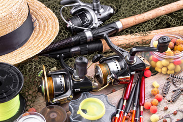 fishing tackle on a wooden table. toned image 