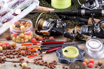fishing tackle on a wooden table. toned image 