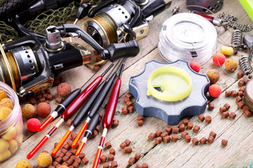 fishing tackle on a wooden table. toned image 