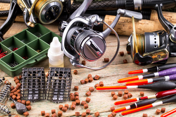 fishing tackle on a wooden table. toned image 