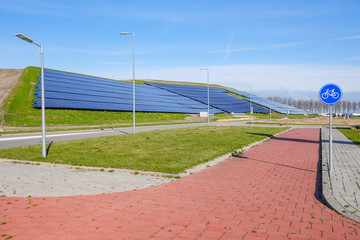 A hilside ful of solar panels providing clean electric power