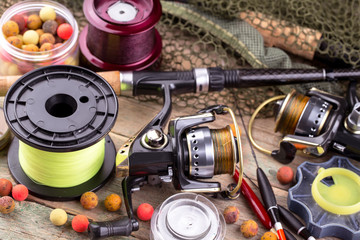 fishing tackle on a wooden table. toned image 