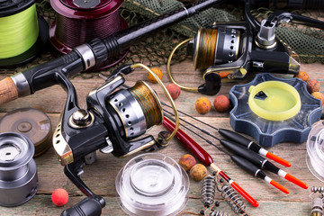 fishing tackle on a wooden table. toned image 