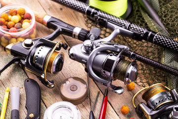 fishing tackle on a wooden table. toned image 