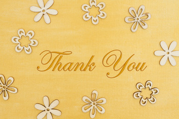 Thank you message with wood flower petals on hand painted distressed gold