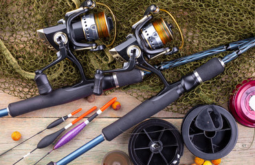 fishing tackle on a wooden table. toned image 