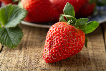 Fresh, tasty summer strawberrie. close up ripe strawberry on wooden board. Summer day light.
