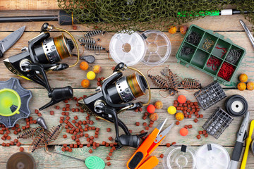 fishing tackle on a wooden table. toned image 