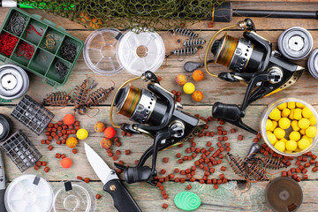 fishing tackle on a wooden table. toned image 