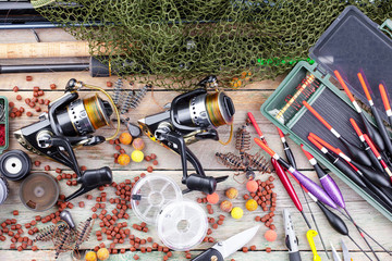 fishing tackle on a wooden table. toned image 