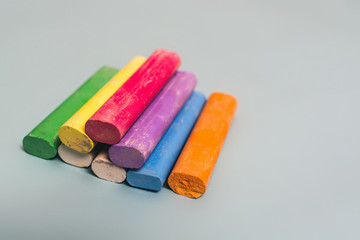 Colorful chalk on blue background.