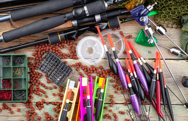 fishing tackle on a wooden table. toned image 