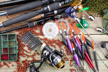 fishing tackle on a wooden table. toned image 