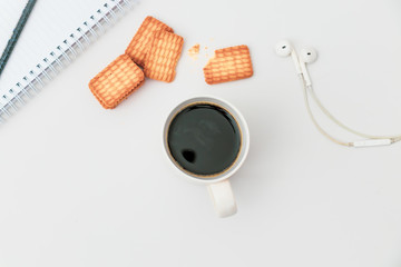 Cup of coffee and biscuit on table Flat lay