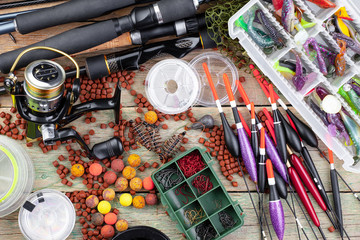 fishing tackle on a wooden table. toned image 