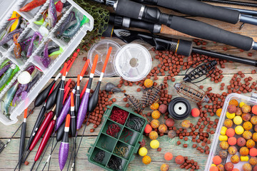 fishing tackle on a wooden table. toned image 