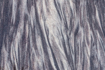 Abstract texture background of a beach with a black sand