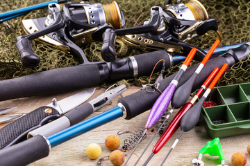 fishing tackle on a wooden table. toned image 