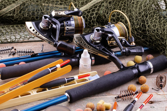 fishing tackle on a wooden table. toned image 