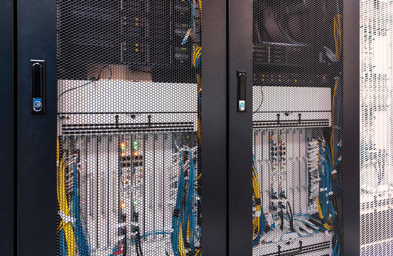 view on the grid server-side doors with equipment of the mobile connection hardware inside. Red toning, depth of field, background blur