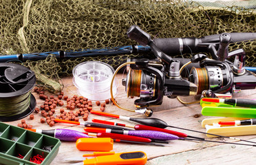 fishing tackle on a wooden table. toned image 