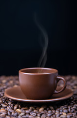 Steaming coffee cup on black  background,