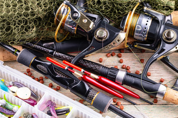 fishing tackle on a wooden table. toned image 