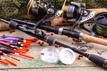 fishing tackle on a wooden table. toned image 