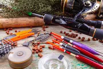 fishing tackle on a wooden table. toned image 
