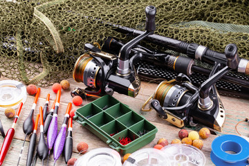 fishing tackle on a wooden table. toned image 