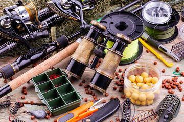 fishing tackle on a wooden table. toned image 