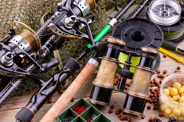 fishing tackle on a wooden table. toned image 