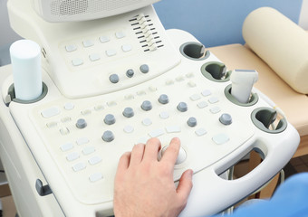 Fototapeta na wymiar Sonographer operating modern ultrasound machine in clinic, closeup