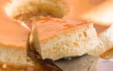 Milk Pudding or Pudim de leite. Brazilian dessert homemade caramel custard pudding and condensed milk. Traditional brazilian flan. Blurred background.
