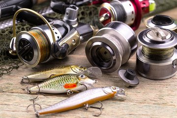 fishing tackle on a wooden table. toned image 