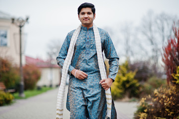 Indian man wear on traditional clothes with white scarf posed outdoor.
