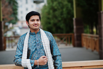Indian man wear on traditional clothes with white scarf posed outdoor.