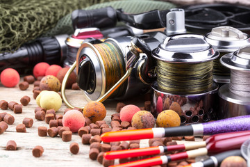 fishing tackle on a wooden table. toned image 