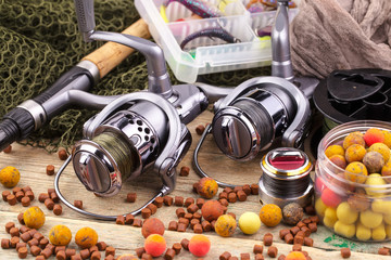 fishing tackle on a wooden table. toned image 
