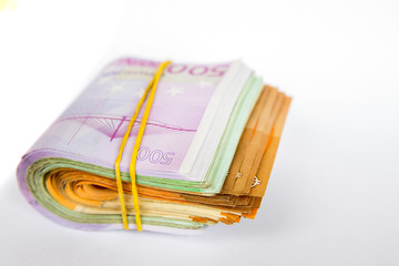 Pile of Euro banknotes isolated on a white background