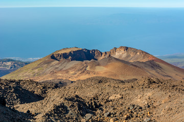 Aerial view of volcano cone raising above ocean