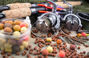 fishing tackle on a wooden table. toned image 