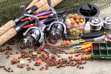 fishing tackle on a wooden table. toned image 